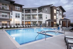 a swimming pool in front of an apartment building