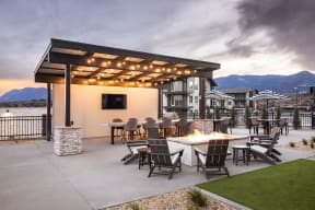 Outdoor entertainment kitchen with TV and firepit