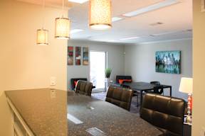 A conference room with a table and chairs.