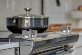 A pot sits on a stove with two burners.