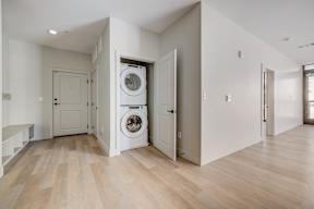 A laundry room with a washer and dryer built into the wall.