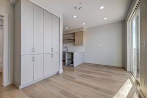 A room with a white cabinet and a wooden floor.