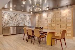 A modern dining room with a large table and chairs.