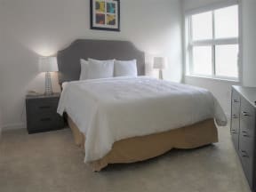 One BR Apartments in Mountain View CA - mResidences Mountain View - Carpetted Bedroom with Bed, Nightstands, and Window