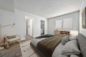 A bedroom with an open door leading to the living room in our apartments for rent in Avondale at Newport.