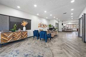 Clubhouse lobby at Newport with a wood floor and seating area in our apartments for rent in Avondale, AZ.