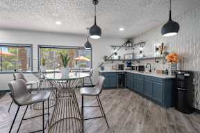 A modern dining room with a glass table and chairs.