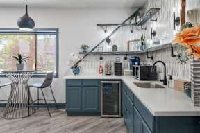 A kitchen with a white countertop and a grey cabinet.
