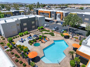 Aerial view of pool with lounge chairs at Newport apartments in Avondale, AZ.
