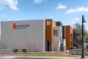 A building with the sign Newport Apartment Homes is shown.