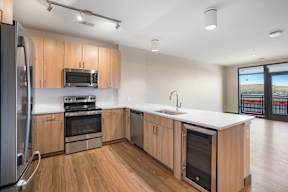Kitchen with built-in beverage cooler or wine fridge  at Novus, Lone Tree, Colorado