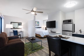 One BR Apartments in Sunnyvale, CA - mResidences Silicon Valley - Interior Shot Of The Kitchen Featuring Dark Cabinetry, White Countertops, and Countertop Seating