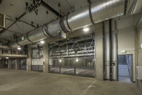 a large industrial building with a large metal duct running through the center of the building