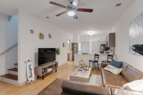 a living room with a couch and a ceiling fan