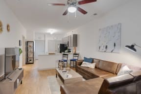 a living room with a couch and a ceiling fan