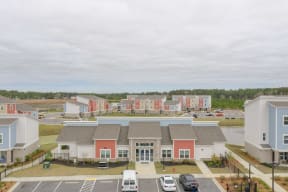 an aerial view of a group of houses in a parking lot