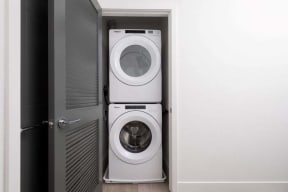 a white washer and dryer in a small closet