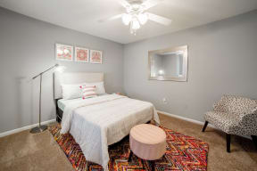a bedroom with a bed and a ceiling fan