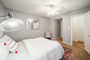 a bedroom with a bed and a ceiling fan
