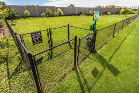 a chain link fence with a sign on it in a field