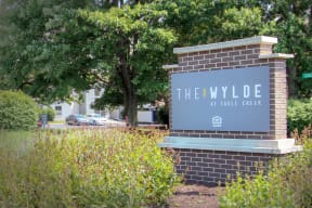 a sign for the hyde at care creek in front of a tree