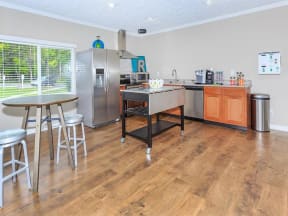a kitchen with a counter and a table with chairs