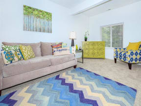 a living room with a couch and a rug
