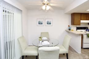 a dining room with a glass table and chairs