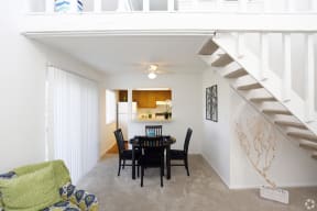 a dining room with a table and chairs in a living room