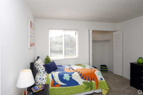 a bedroom with a bed and a window and a closet