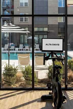 Fitness Center with pool view at Alta Davis, Durham