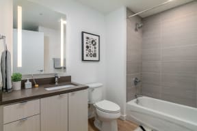 a bathroom with a toilet and a tub and a sink