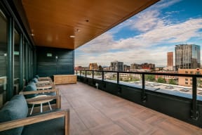 a balcony with a view of a city and a city skyline