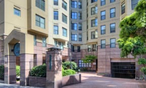 an entrance to an apartment building with a walkway in front of it