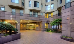 an empty courtyard in front of an apartment building