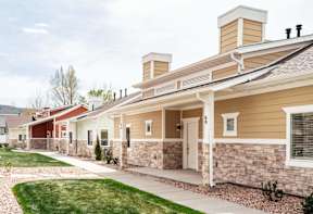 a row of houses with a sidewalk in front of them