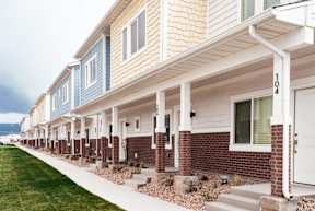 a row of townhomes with blue and white siding