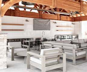 a seating area of a restaurant with wooden chairs and tables