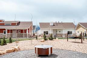 a backyard with a fire pit and some houses