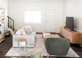 a living room with a white couch and a television