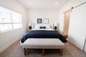 a bedroom with a large bed and a window