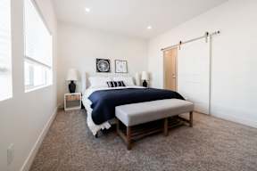 a bedroom with a large bed and a white closet