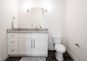 a white bathroom with a toilet and a sink