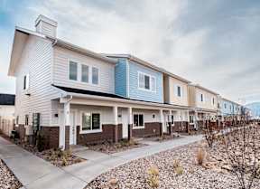 a street view of a row of houses with a sidewalk