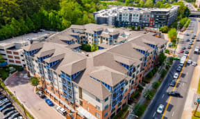 a view of a building from above with cars parked in front of it