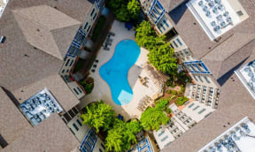an overhead view of a pool in the middle of an apartment building