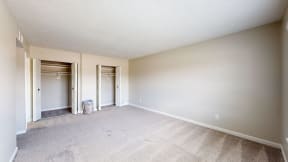 an empty living room with white walls and carpet