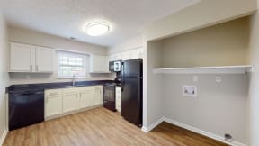 a view of a kitchen with a refrigerator and a sink