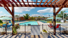 our apartments have a resort style pool with chairs and umbrellas