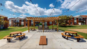 a picnic area with benches and a pergola
